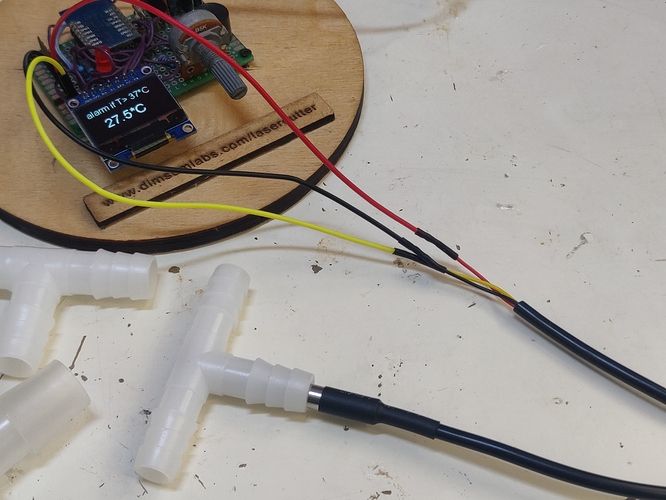 Photo of probe in T-fitting, connected to MCU with temperature display